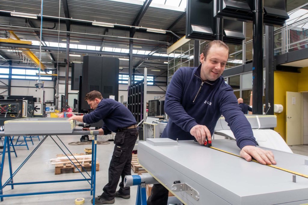 Medewerker verricht maatwerk aan de kast van een displayoplossing